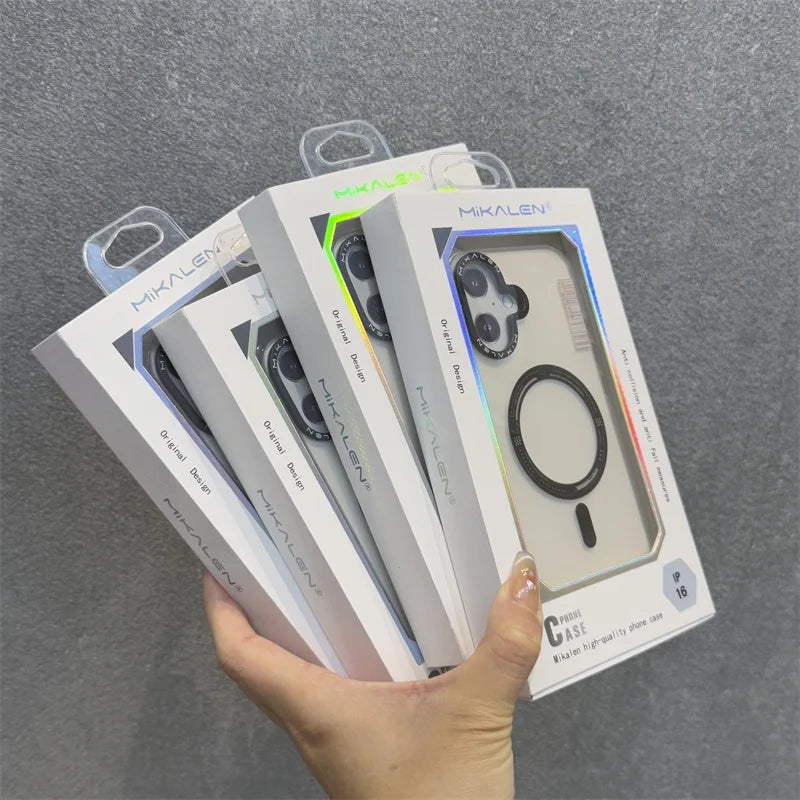 A hand holding five boxed clear phone cases with a circular magnetic ring.