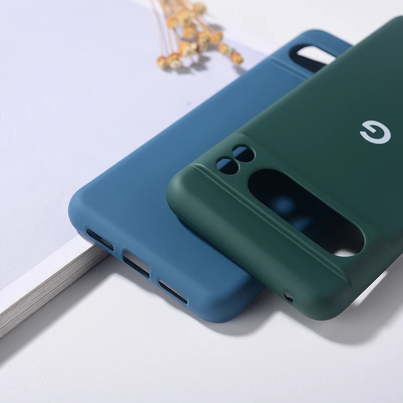 Two silicone phone cases, one blue and one green, with cutouts for cameras and ports.