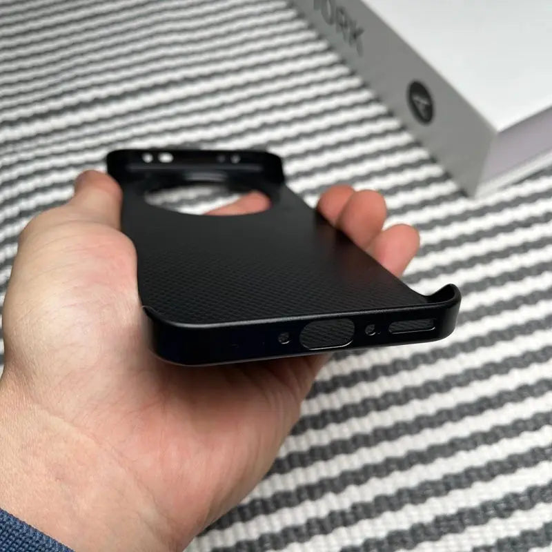 A black smartphone case with a textured back and precision cutouts for ports and buttons.