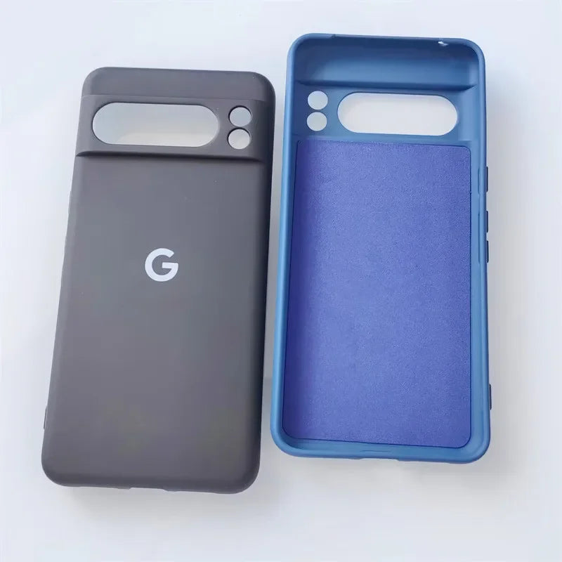 Two smartphone cases, one dark gray with a Google ’G’ logo and the other blue with a textured interior.