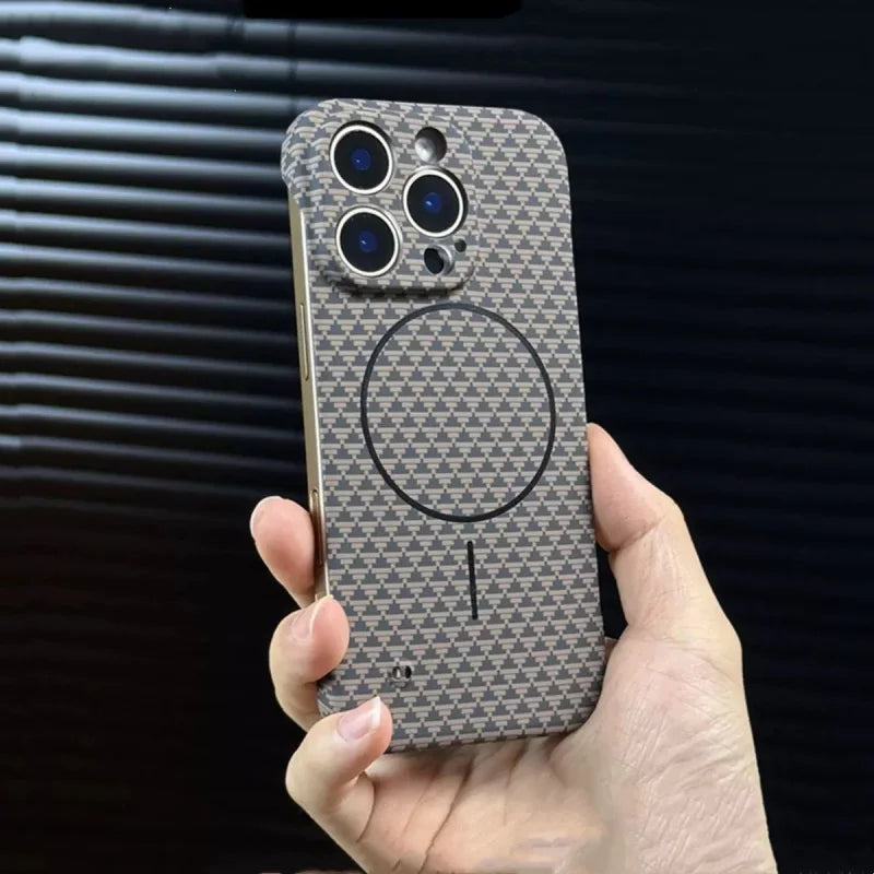Hand holding a patterned smartphone case with visible camera cutouts and a MagSafe ring.