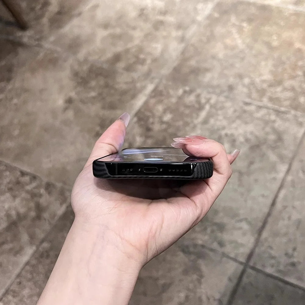 A hand holding a smartphone in a clear case.