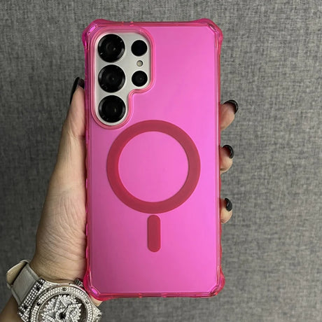 Pink phone case with a transparent back, reinforced corners, and a circular magnetic ring for wireless charging.
