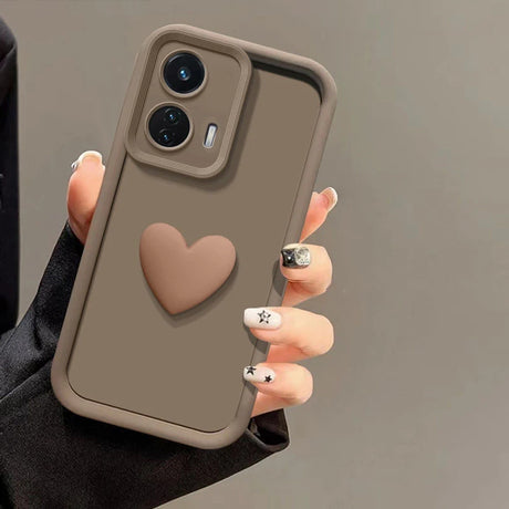 A brown smartphone case with a raised heart design and a camera cutout.
