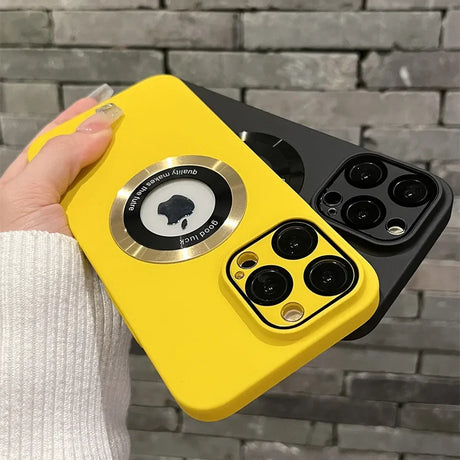 Two brightly colored iPhone cases, one yellow and one black, with prominent camera cutouts and a circular magnetic ring on the yellow case.