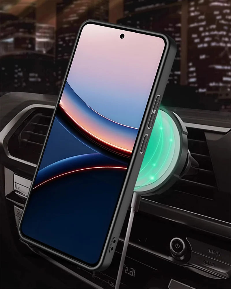 A smartphone with a black case mounted on a car vent charger.