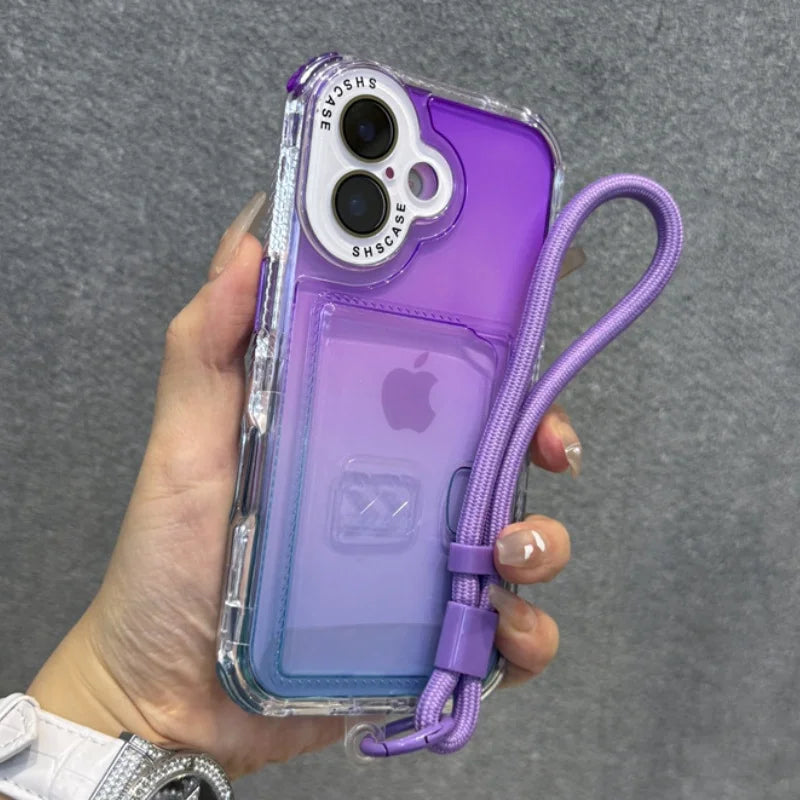 Purple and blue gradient iPhone case with a transparent card slot, a clear outer bumper, and an attached purple wrist strap.