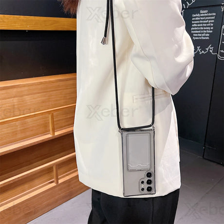 A clear phone case with a black lanyard and a rectangular card slot on the back.