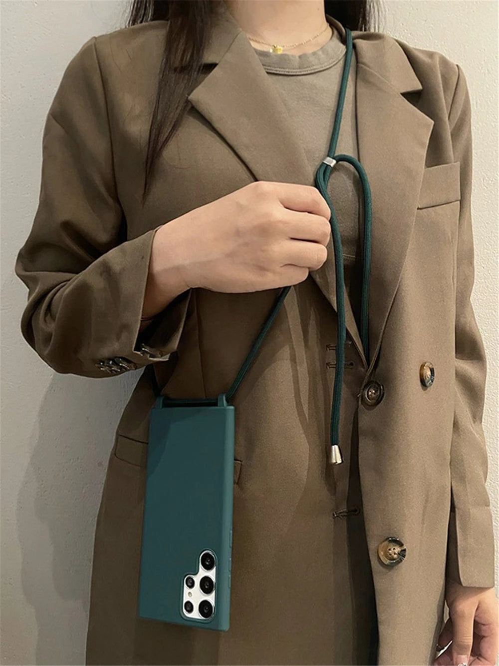 Teal silicone phone case with a shoulder strap for a Samsung Galaxy S23 Ultra.