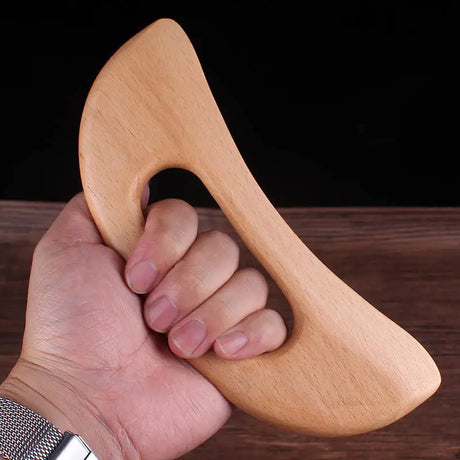 a hand holding a wooden hammer