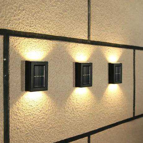 a wall with three lights on it