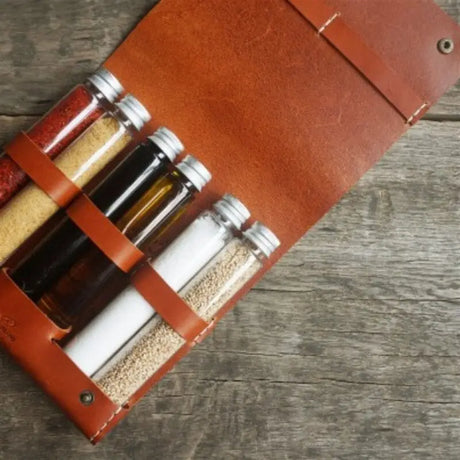 a leather wine bottle carrier with a corked cork