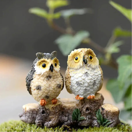 two small birds sitting on a tree stump