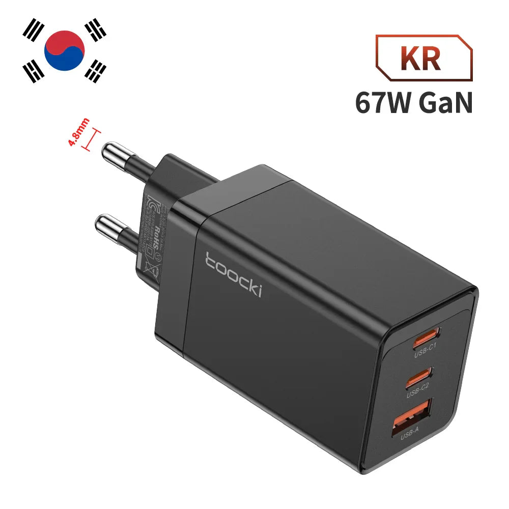 Black 67W GaN charger with three USB ports and a South Korean plug.