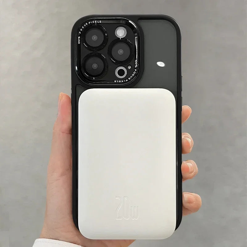 Black-cased smartphone with white MagSafe battery pack.