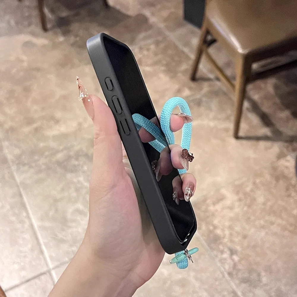 Black phone case with turquoise strap.