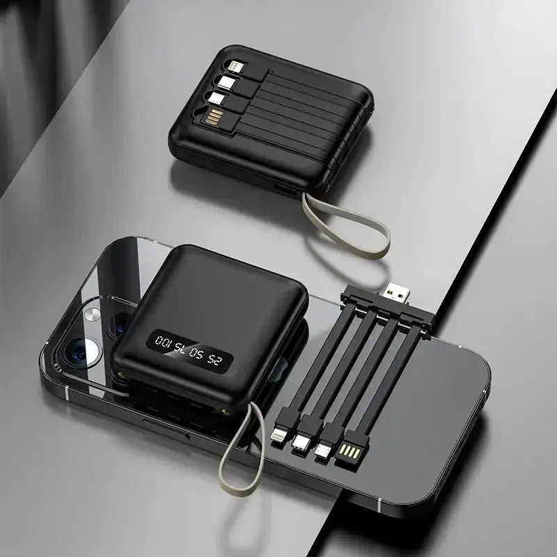 a black phone and a black charger on a table