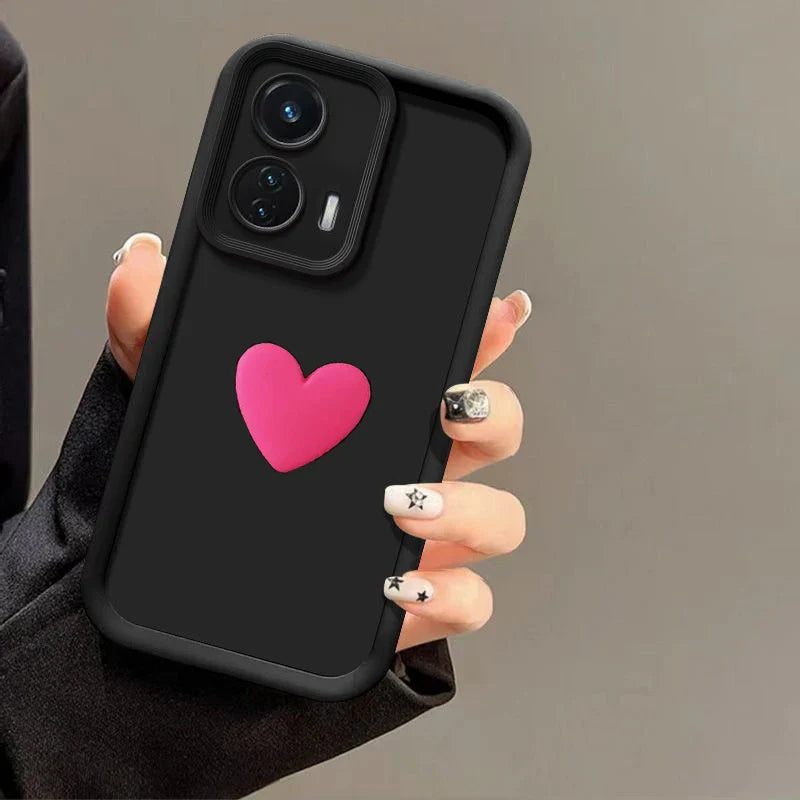 Black smartphone with a pink heart on its case.