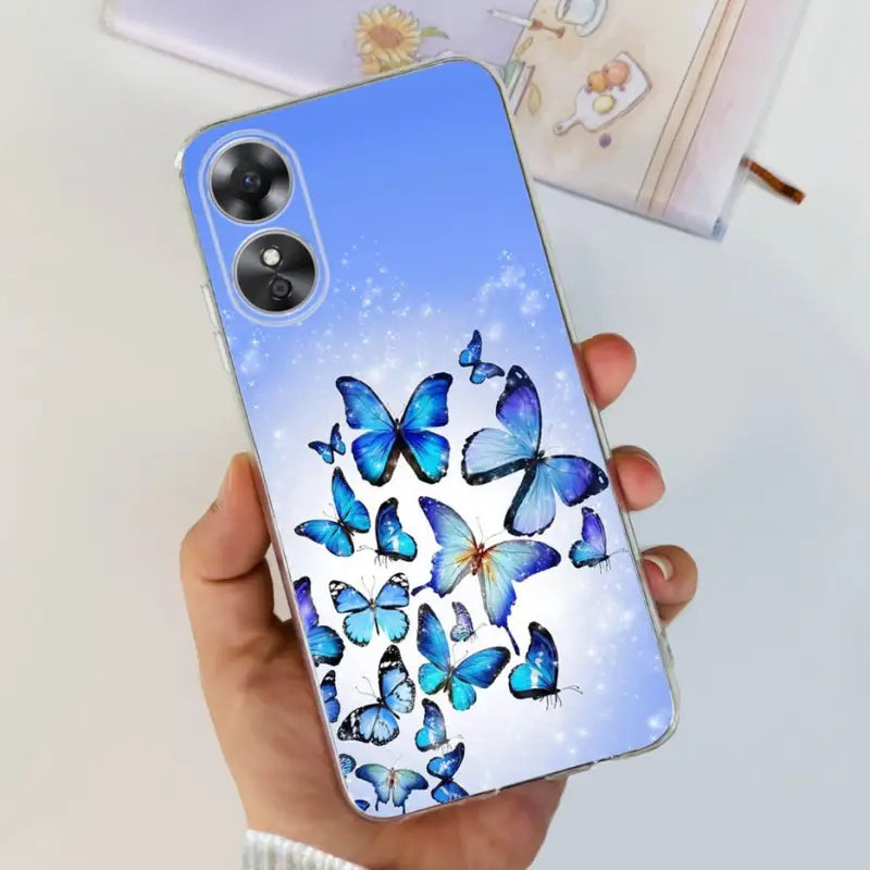 a woman holding a phone case with butterflies on it