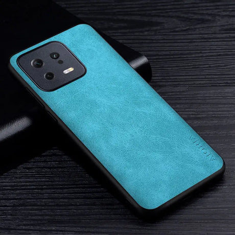 the back of a blue leather case on a black table