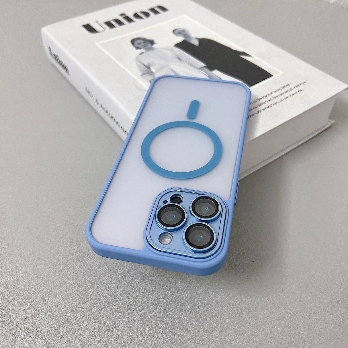 Blue-trimmed clear phone case with magnetic ring.