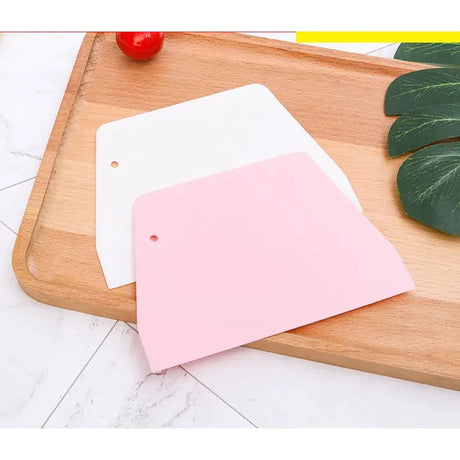 a cutting board with a pink paper on it