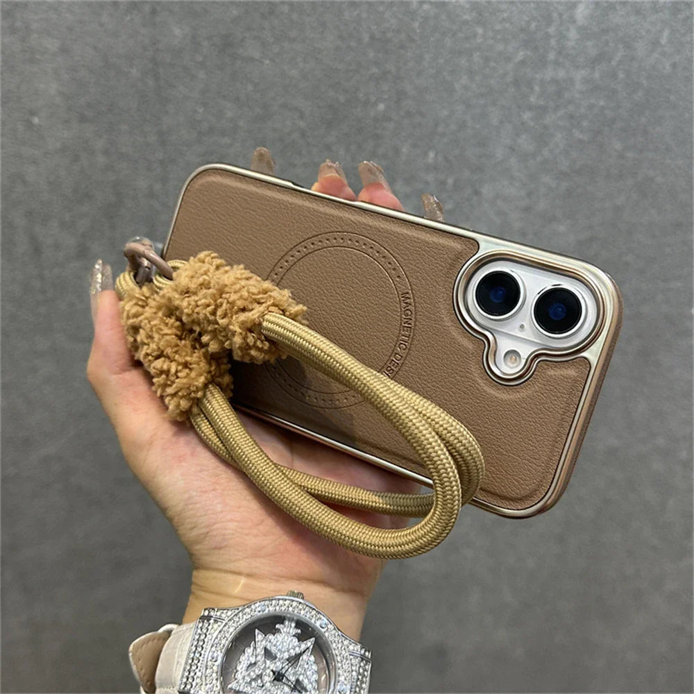 Brown leather-like phone case with fluffy wrist strap.