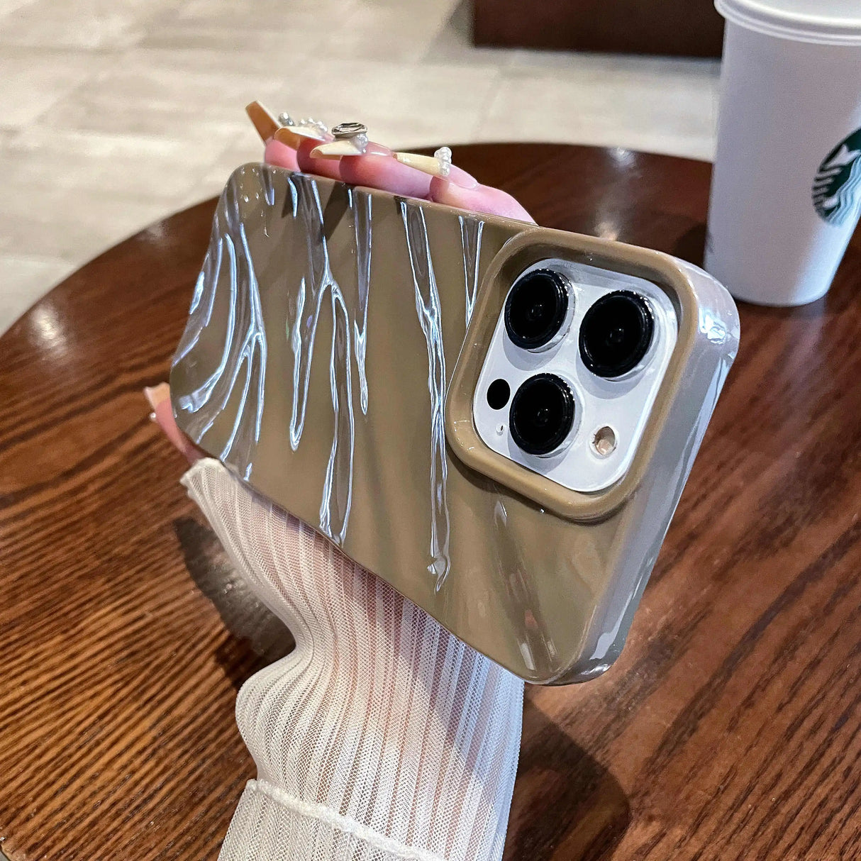 Brown phone case with silver dripping design.