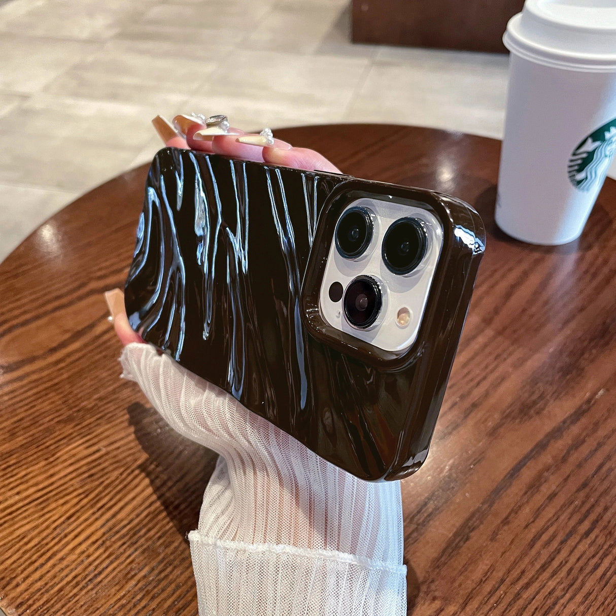 Brown phone case with wavy design.