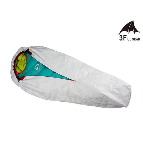 a white sleeping bag with a green and yellow design