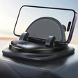 Car dashboard phone holder with a circular base and adjustable cradle for securing a smartphone.