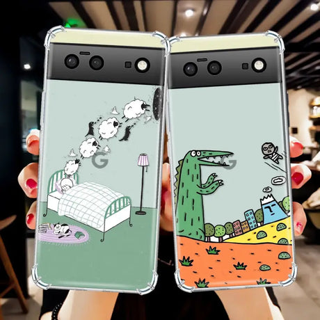 two cell phones with a cartoon dinosaur and a bed on them