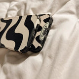 a close up of a cell phone case laying on a bed
