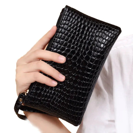 a woman holding a black wallet