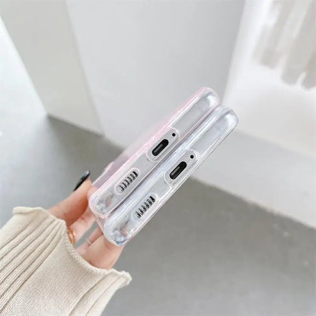 a woman holding a clear phone case