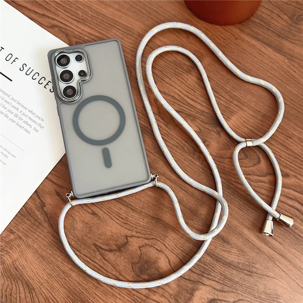 A clear phone case with a Magsafe ring and an attached light-colored braided cord strap.