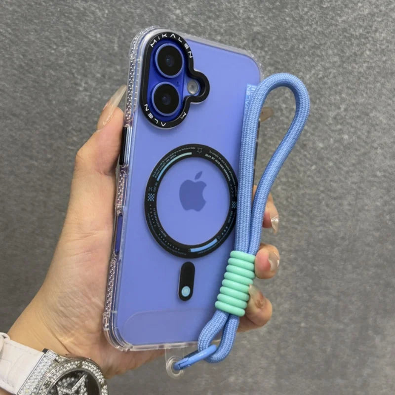 Clear phone case with a purple back, black camera lens protector, a black MagSafe ring, and a light blue braided wrist strap with mint green silicone rings.
