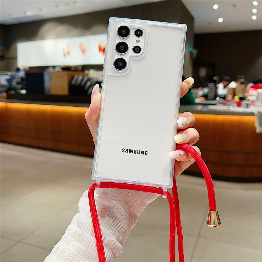 Clear phone case with a red lanyard for a Samsung phone.