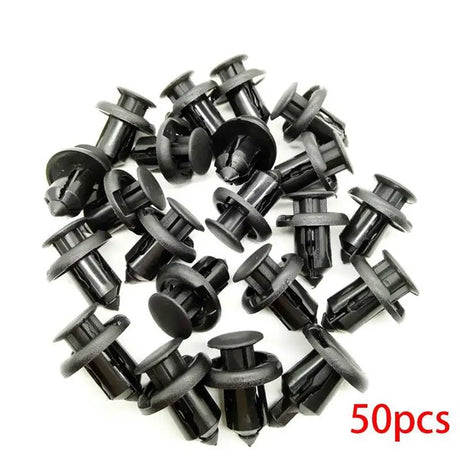 a close up of a bunch of black plastic screws on a white surface
