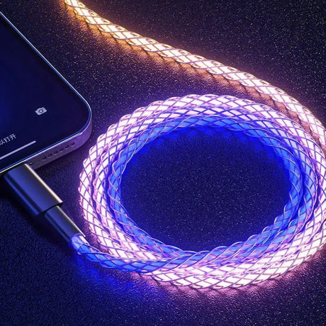 a close up of a cell phone connected to a glowing cable