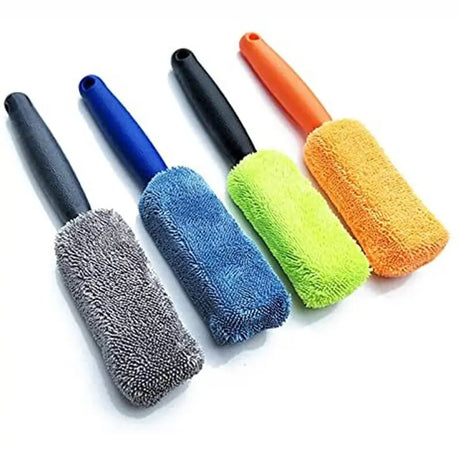 four different colored microfill cleaning brushes on a white surface