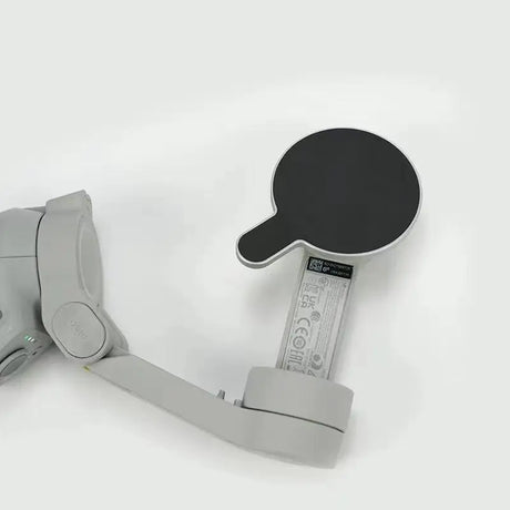 a metal object with a black handle