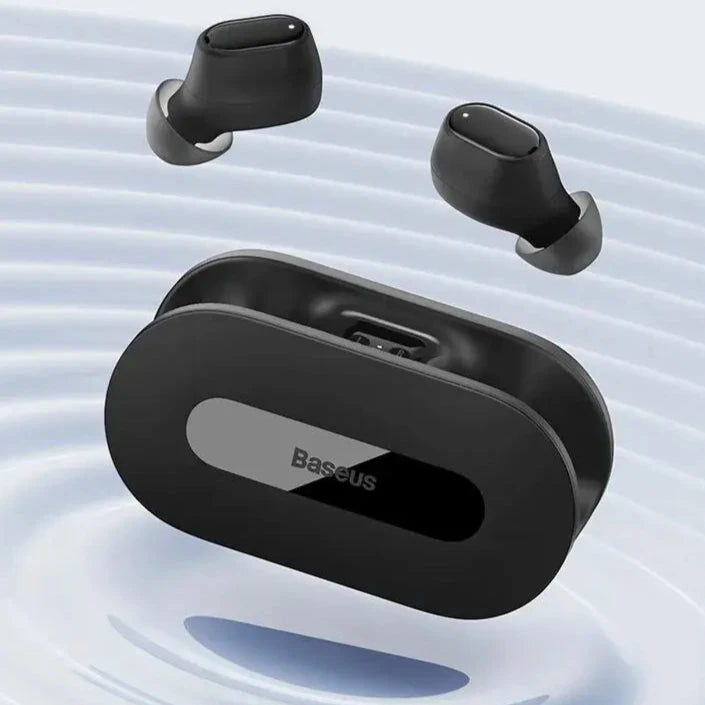 A close up of a pair of black earphones floating in water