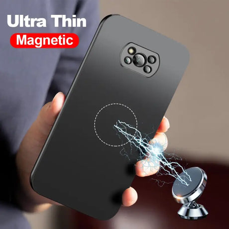 a close up of a person holding a cell phone with a magnet