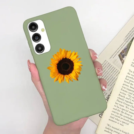 a woman holding a phone case with a sunflower on it