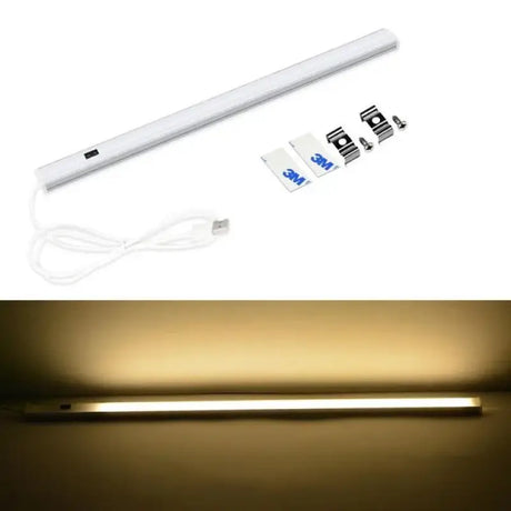 A close up of a white light with a cord and a remote control