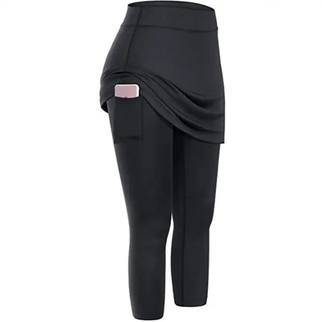 a close up of a woman’s black skirted leggings with a pink pocket