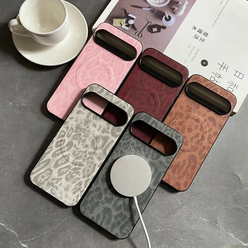A collection of five phone cases in various colors and patterns, with a circular magnetic charging attachment on one.
