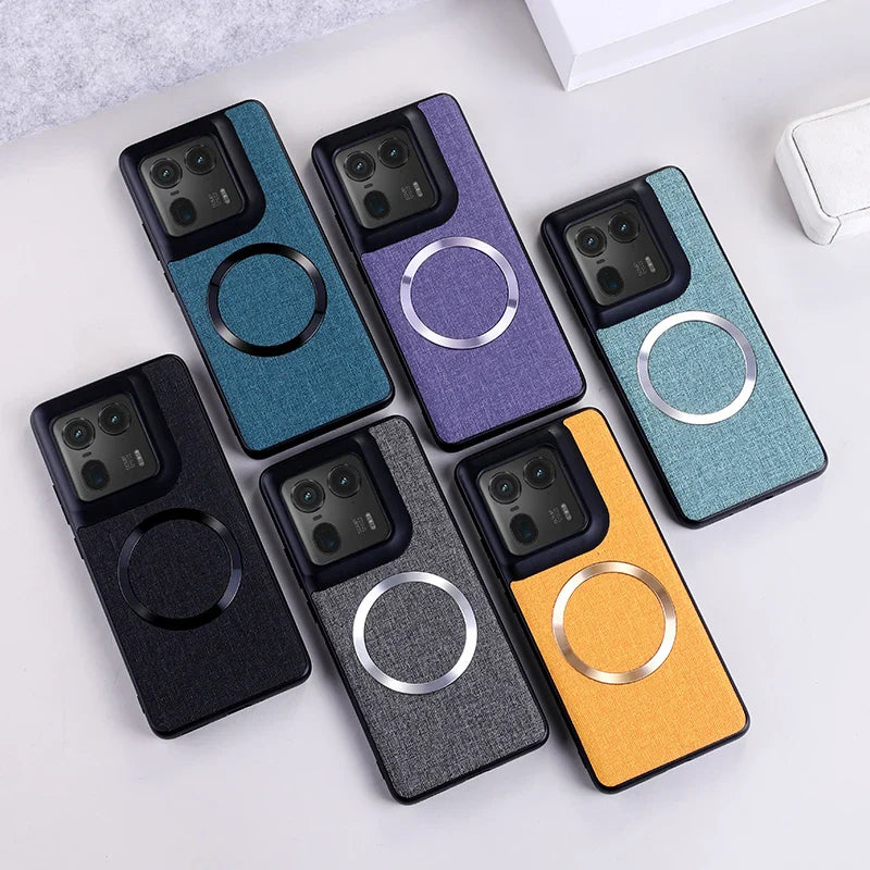 A collection of six smartphone cases in various colors, featuring a textured fabric-like finish and a circular magnetic ring on the back.