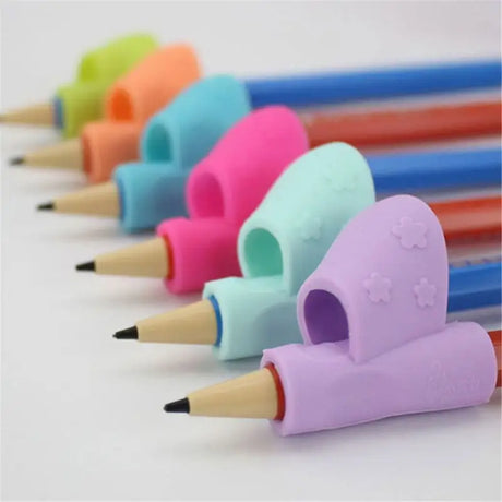 a group of colored pencils with a heart shaped eraser